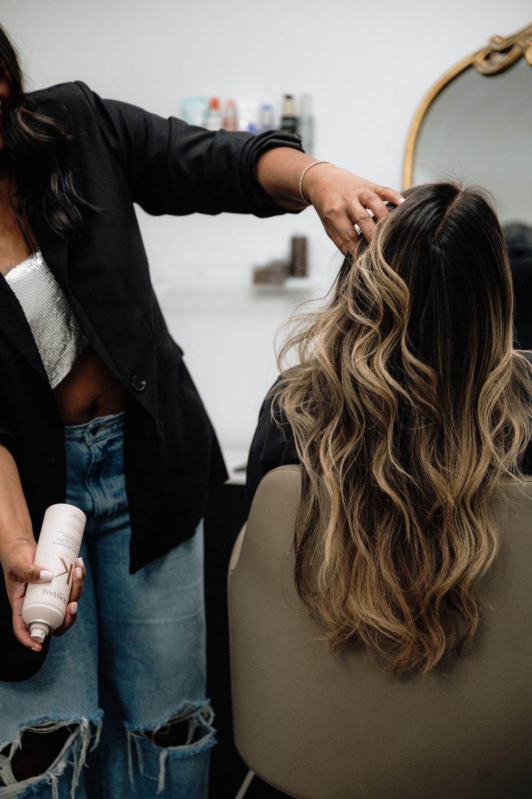 Stylist spraying hair close-up view