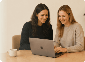 Team members collaborating at a computer desk